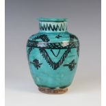 A Persian Kashan turquoise glazed pottery vase, the high shouldered cylindrical body decorated