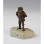 An Austrian patinated bronze figure of a winter boy, circa 1910, modelled walking with gloves, scarf