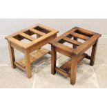 A pair of honey oak luggage stands, 20th century, each with a rectangular slatted top on legs of