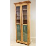 A Victorian and later constructed pine glazed bookcase, the moulded cornice above a pair of glazed