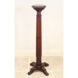 A 19th century mahogany torchere, the 25cm top with a carved frieze raised upon a reeded and lobed