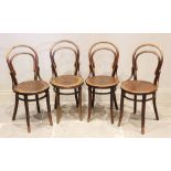 A set of four early 20th century stained beech wood 'Thonet' bentwood chairs, each with a typical