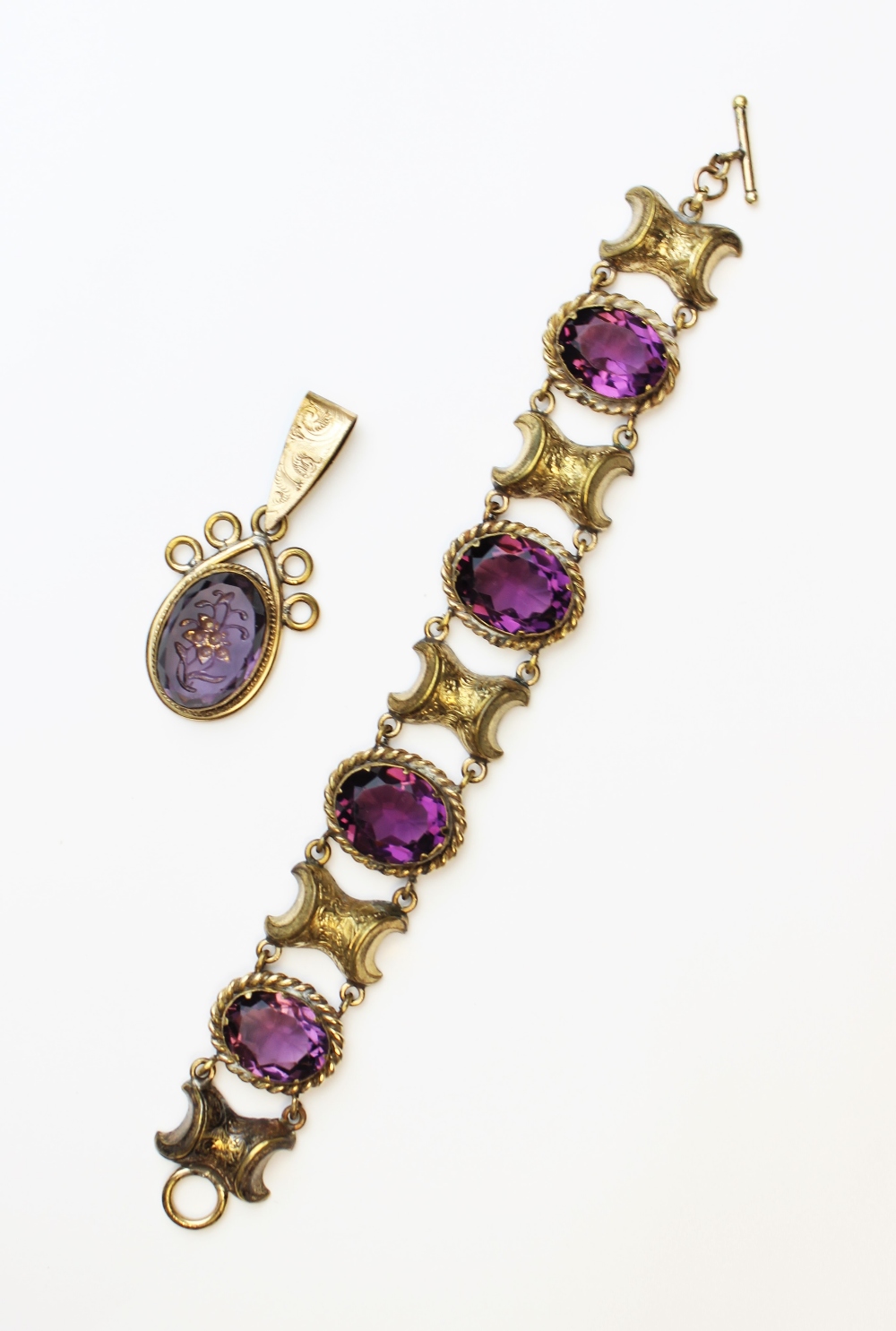 A Victorian style paste set bracelet, comprising four oval mixed cut purple paste, each measuring