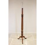 An early 20th century mahogany standard lamp, the wrythen and acanthus leaf carved column