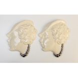 A pair of Art Deco silver lustre porcelain wall masks, each modelled as a young lady in a hat with