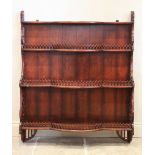 A reproduction stained hardwood wall shelf, the three break arch open shelves with a pierced