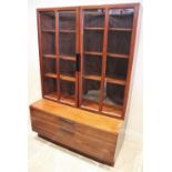 A mid century Danish rosewood wall cabinet designed by Ib Kofod Larsen for Faarup Mobelfabrik,