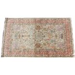A Persian pattern silk work rug, the stylised mirrored garden design upon an ivory coloured