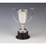 A George V silver twin-handled trophy cup by Alexander Clark & Co Ltd, Birmingham 1930, the bell