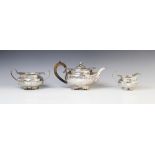 A George III silver three piece tea service by Joseph Angell I, London 1815, comprising teapot, milk