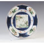 A Chinese porcelain famille verte and powder blue plate, Kangxi (1661-1722), the circular