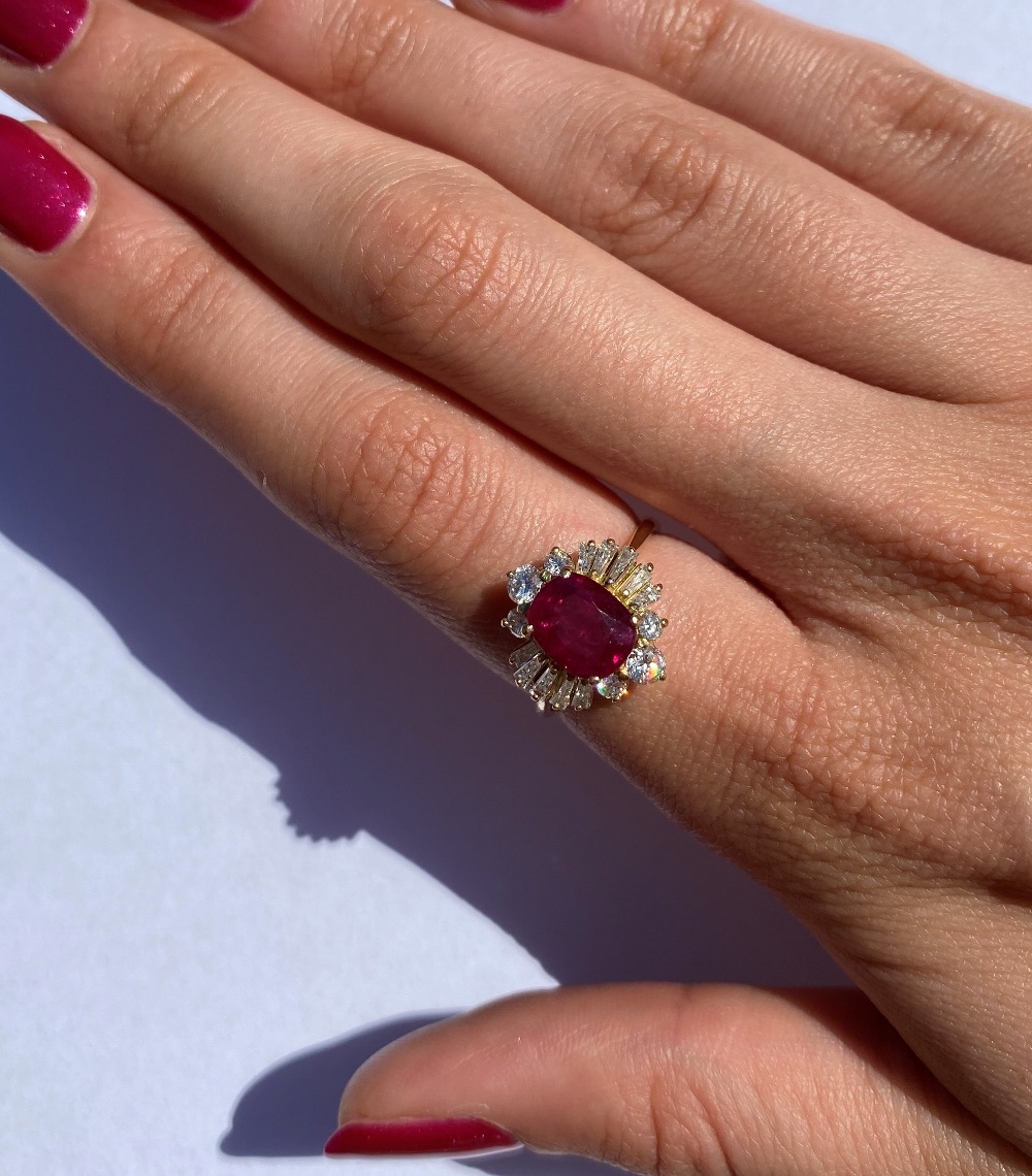 A ruby and diamond cluster ring, the central rectangular cushion cut ruby (measuring 8.2 x 6.6 x 4. - Image 2 of 10