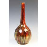 A Burmantofts art pottery faience vase, circa 1900, of bottle form in red, yellow, green and ochre