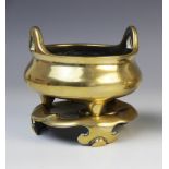 A Chinese bronze censer and stand, late 19th century, the censer of compressed circular form