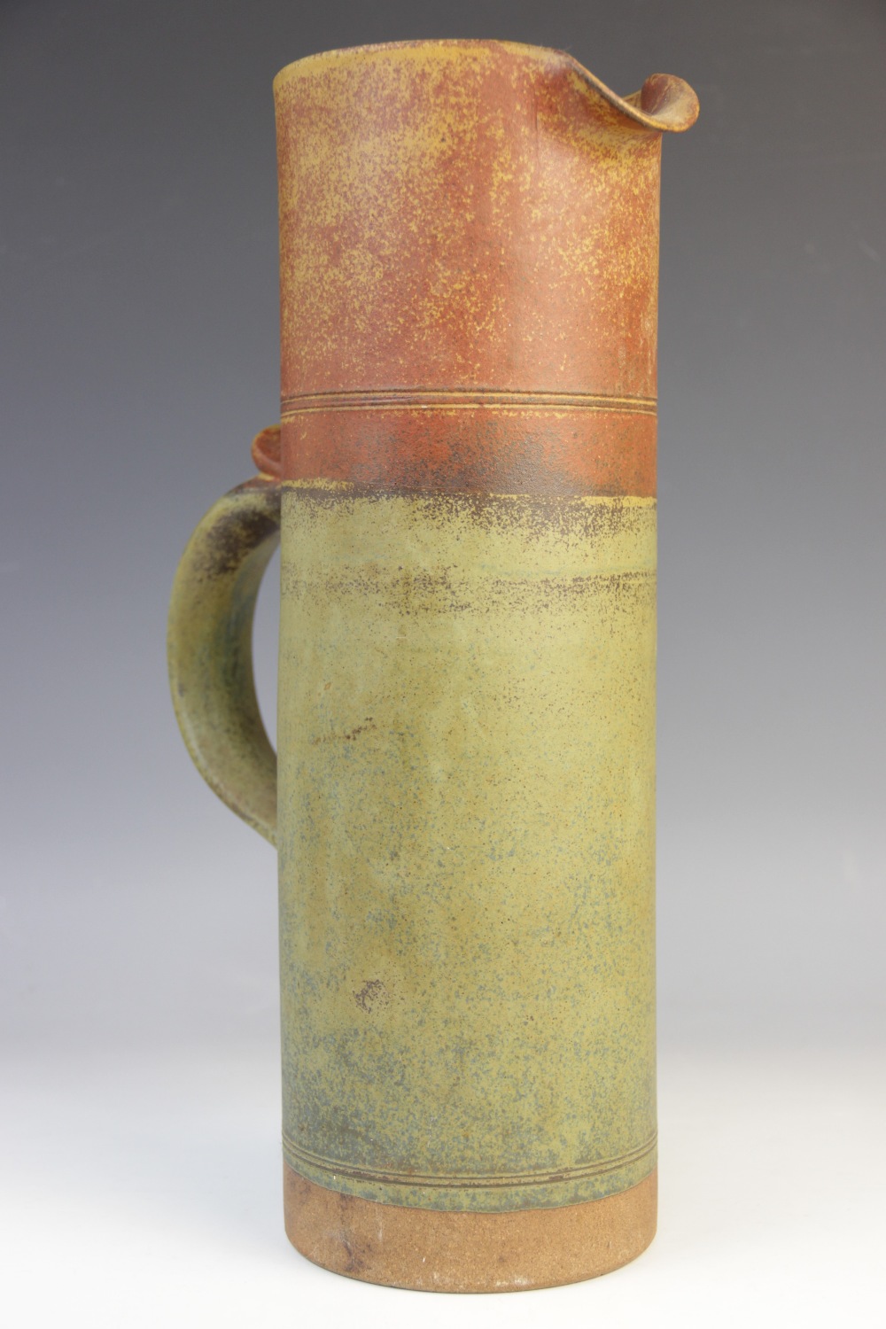 A Robin Welch (British, 1936-2019) cylindrical stoneware ewer, applied loop handle with