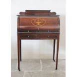 An Edwardian inlaid mahogany cylinder top bureau, the shaped pediment above a fall front centred