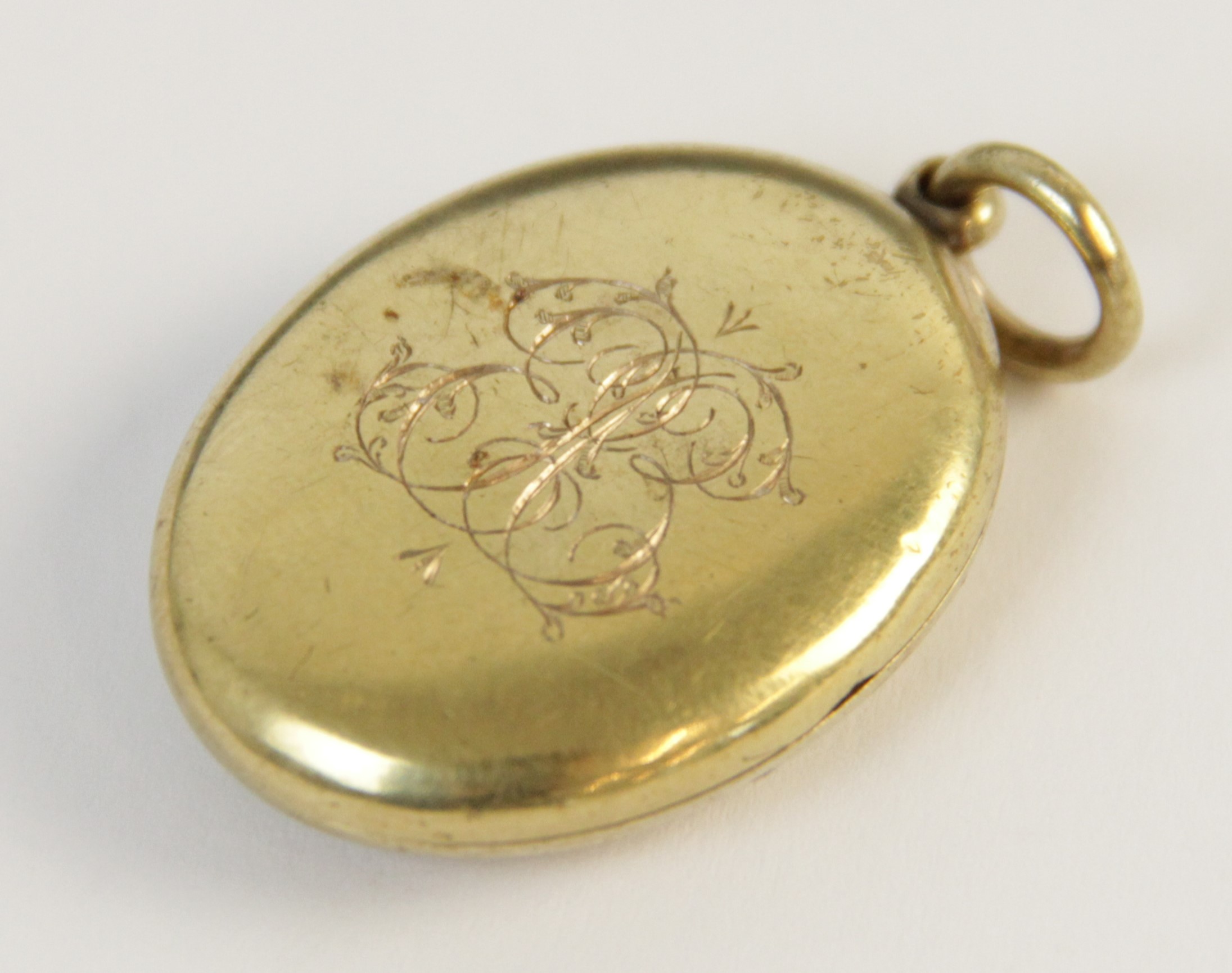 An early 20th century gold coloured enamelled locket pendant, the oval form locket with a blue - Image 8 of 8