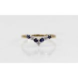 A diamond and sapphire 9ct gold chevron ring, comprising three round mixed cut diamonds and four