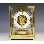 A Jaeger-LeCoultre Atmos clock, serial number 265713, the white enamel bezel applied with gilt metal