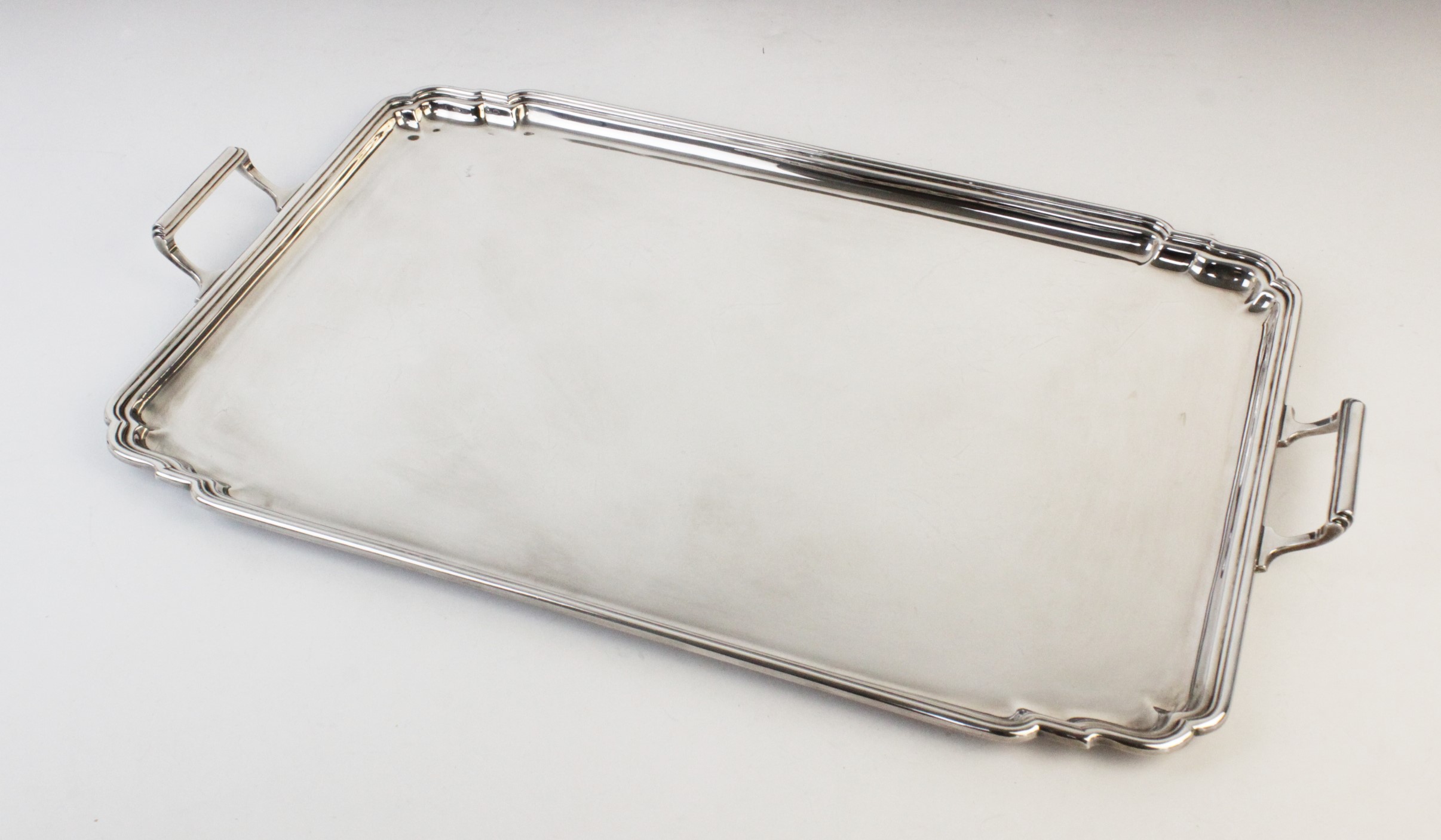 A large twin-handled silver tray by Mappin & Webb, Sheffield 1979, of plain polished rectangular