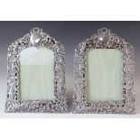A pair of Victorian silver photograph frames by William Comyns, London 1894, of arched rectangular