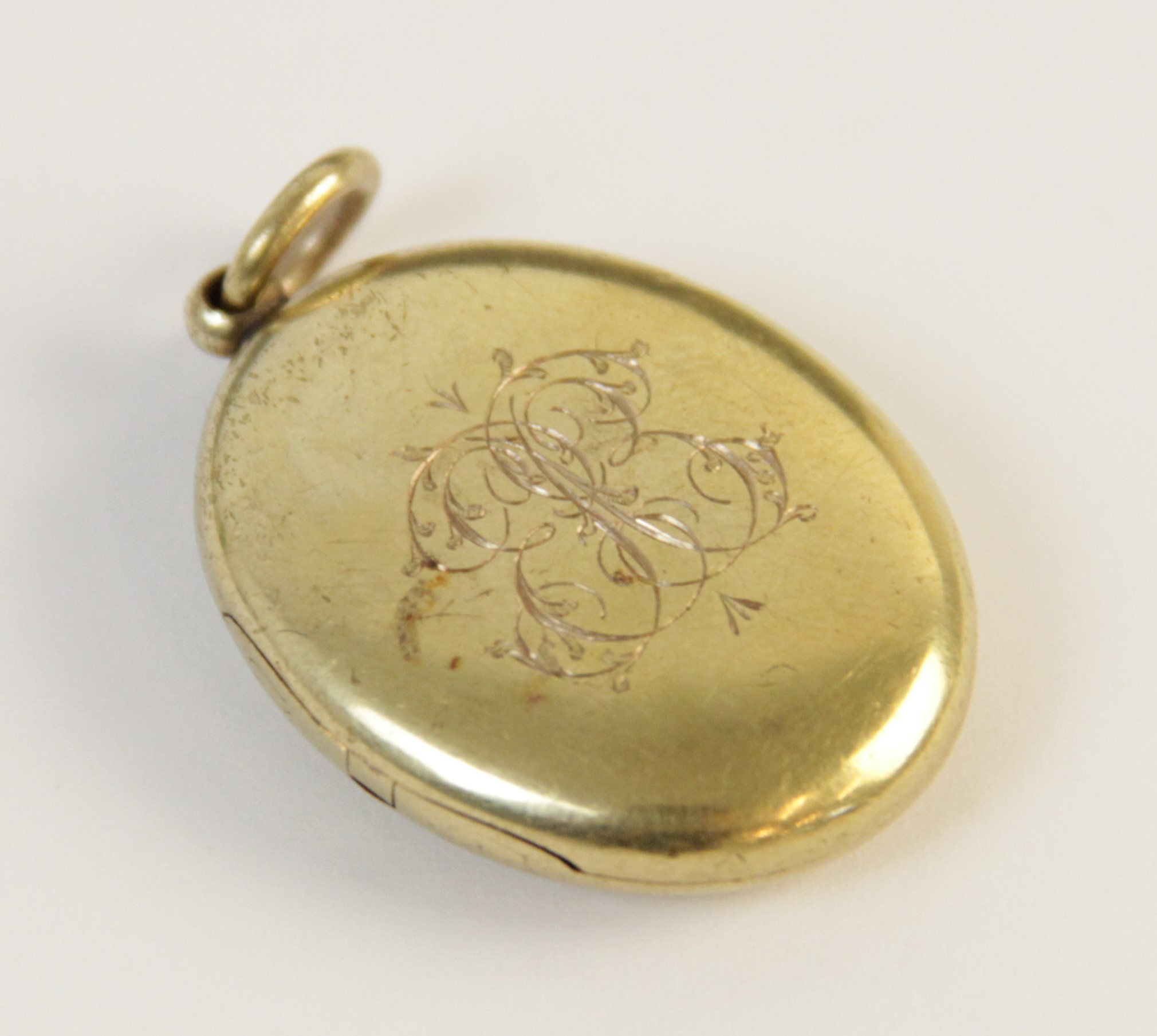 An early 20th century gold coloured enamelled locket pendant, the oval form locket with a blue - Image 5 of 8
