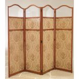 A late 19th century satinwood three fold screen, the four arched sections with a glazed panel over a