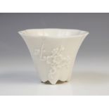 A Chinese blanc de chine Dehua porcelain libation cup, probably 19th century, of lobed spreading