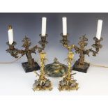A pair of mid 19th century ormolu candlesticks, cast in the form of leafy stems with three cast