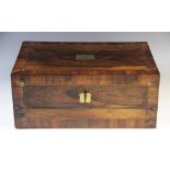 A mid 19th rosewood stationery box, the rectangular hinged cover centred with a shaped and