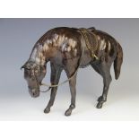 A leather figure of a horse, 20th century, possibly Abercrombie and Fitch, modelled head lowered,