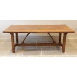 An early 20th century Arts and Crafts honey oak refectory table in the manner of Ernest Gimson