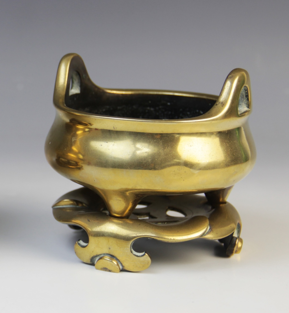 A Chinese bronze censer and stand, late 19th century, the censer of compressed circular form