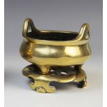 A Chinese bronze censer and stand, late 19th century, the censer of compressed circular form