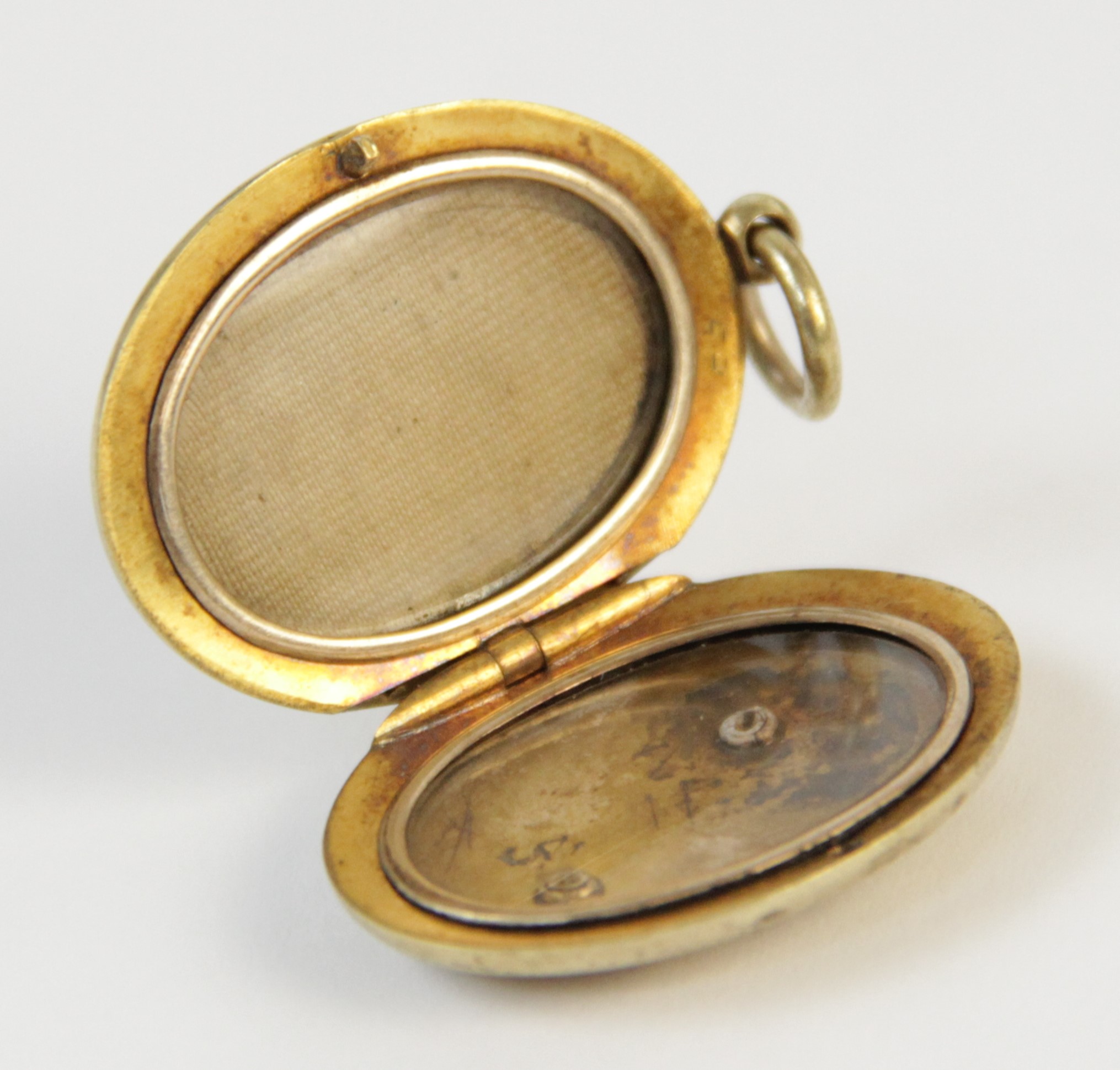 An early 20th century gold coloured enamelled locket pendant, the oval form locket with a blue - Image 7 of 8