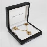 A suite of 9ct gold jewellery by Catherine Best, comprising a spiral design pendant, 29mm long,