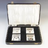 A cased set of four silver dishes, Henry Matthews, Birmingham 1930, each of square form with later
