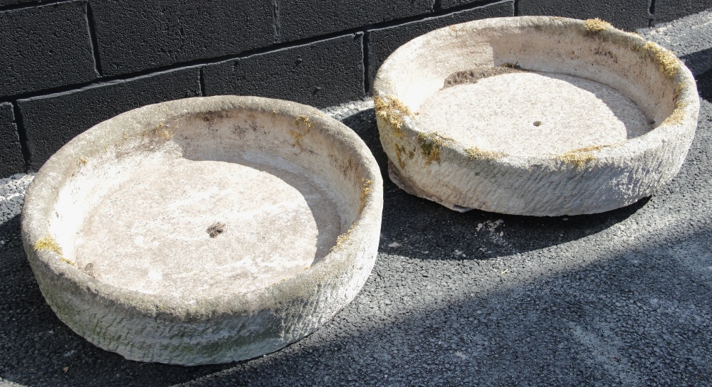 A pair of shallow circular reconstituted stone troughs, 17cm H x 75cm D (2)