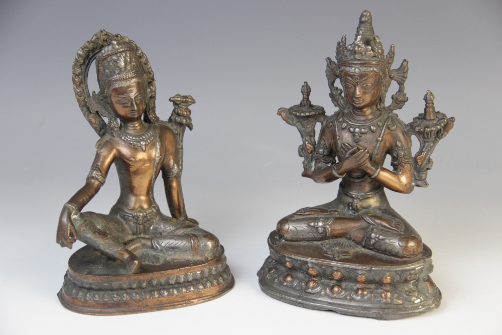 Two Indian copper Bodhisattva, each modelled seated on a lotus crown base, 16.5cm and 18cm high (2)