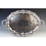 A large twin handled silver-plated presentation tray, 19th century, of oval form with foliate cast