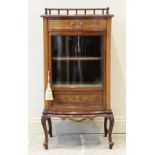 An Edwardian mahogany bowfront display cabinet, the shaped top with a rear spindle gallery, above