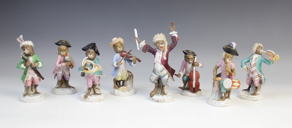 An eight piece German porcelain monkey band, 19th century, comprising: a conductor, a violinist, a