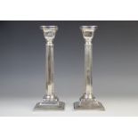A pair of George V silver candlesticks, marks for 'M.S', London 1933, each with faceted stems and