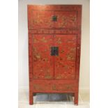 A Chinese red lacquer chinoiserie two piece cabinet, early 20th century, the upper section with