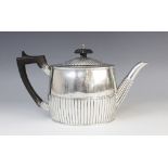 A George III silver teapot by Michael Plummer, London 1793, of oval form with half-reeded