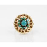 An 18ct gold turquoise set cluster ring, comprising a central turquoise cabochon (measuring 4mm