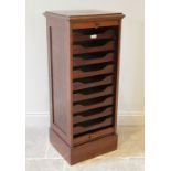 An early 20th century walnut tambour front cabinet, the rectangular moulded top above a tambour