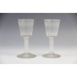 A pair of English wine glasses, 18th century, the conical bowls engraved with a continuous frieze of