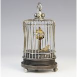 A mid-20th century automaton, modelled as a bird within a wire cage beneath a horary sphere, stamped