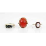 A 9ct gold carnelian set dress ring, the central plain polished carnelian cabochon measuring 18mm